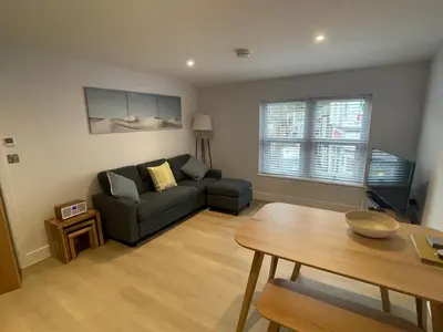 a living room with a couch and a table at Seasteps Padstow in Padstow