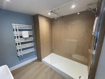 a bathroom with a shower with a glass door at Seasteps Padstow in Padstow
