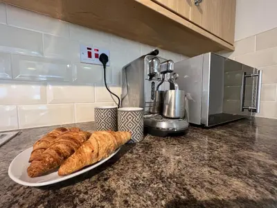 a plate of croissants on a counter in a kitchen at Fulmar Cottage in Mevagissey