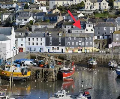 a group of boats docked in a harbor with houses at Fulmar Cottage in Mevagissey