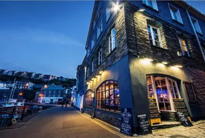 a building with lights on the side of a street at Fulmar Cottage in Mevagissey