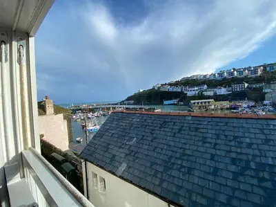 a view of a roof of a building with a harbor at Fulmar Cottage in Mevagissey