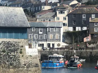 two boats are docked in a body of water at Fulmar Cottage in Mevagissey