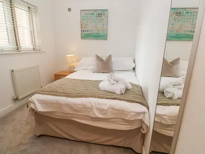 a bedroom with a bed with towels on it at 9 Headland Point in Newquay