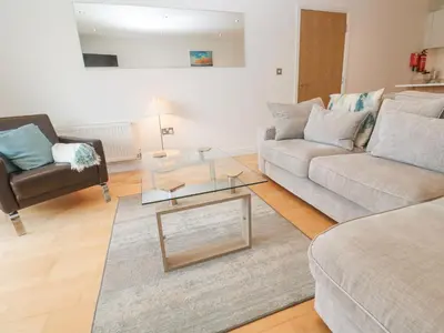 a living room with two couches and a coffee table at 9 Headland Point in Newquay