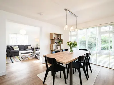 a dining room and living room with a table and chairs at Obo's Retreat in Wadebridge