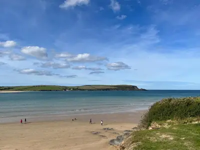 a group of people on a beach near the water at Obo's Retreat in Wadebridge