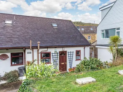 a white house with a brown roof at Mortreth in Porthtowan