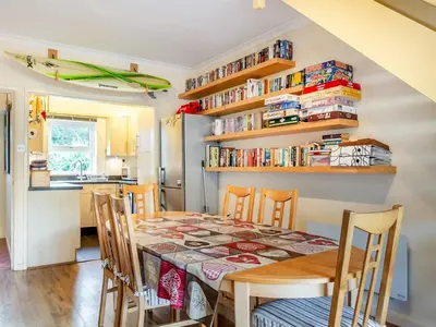 a kitchen and dining room with a table and chairs at Mortreth in Porthtowan