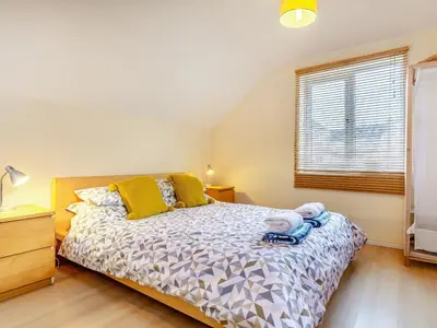 a bedroom with a bed and a window at Mortreth in Porthtowan