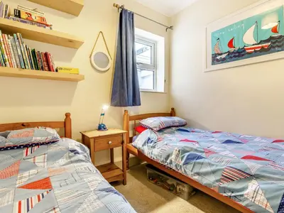 a bedroom with two twin beds and a window at Mortreth in Porthtowan