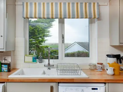 a kitchen with a sink and a window at Semybadazee in Poundstock