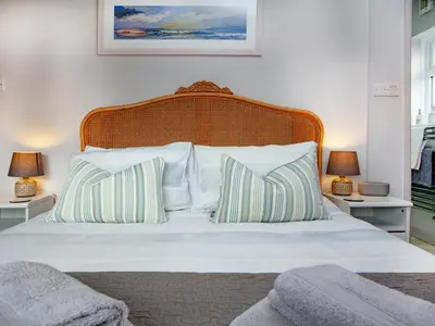 a bedroom with a bed with white sheets and pillows at Semybadazee in Poundstock