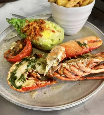 a plate of food with shrimp and vegetables on a table at The Kingswood in St Austell