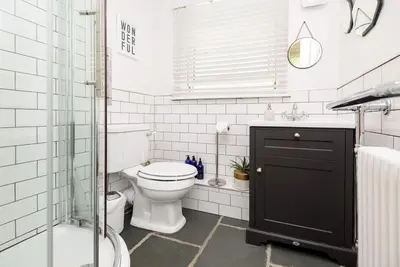 a bathroom with a toilet and a glass shower at Bijou Coastal Apartment in Polperro With Hot Tub, Onsite Parking 5 min Downhill Walk To Village in Polperro