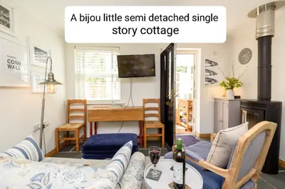 a living room with a blueillinillin sent detached single story cottage at Bijou Coastal Apartment in Polperro With Hot Tub, Onsite Parking 5 min Downhill Walk To Village in Polperro