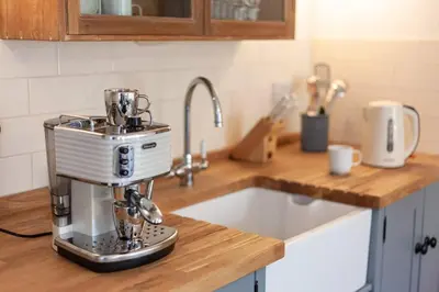 a kitchen counter with a mixer on top of a sink at Bijou Coastal Apartment in Polperro With Hot Tub, Onsite Parking 5 min Downhill Walk To Village in Polperro