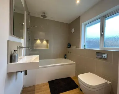 a bathroom with a tub and a toilet and a sink at No.48 Falmouth - 10 minutes walk to the beach in Falmouth