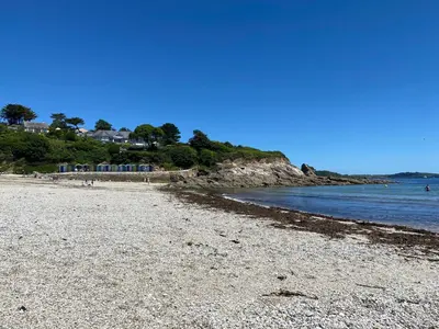a beach with a rocky shore and the ocean at No.48 Falmouth - 10 minutes walk to the beach in Falmouth