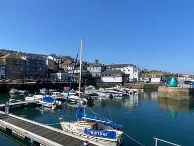 a group of boats docked at a dock in a harbor at No.48 Falmouth - 10 minutes walk to the beach in Falmouth