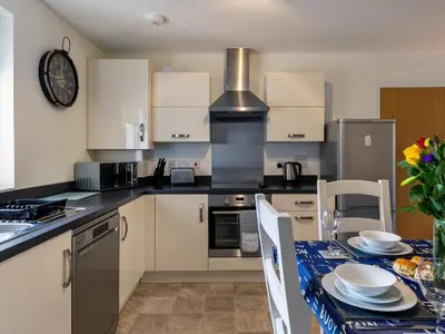 a kitchen with a table with a blue table cloth at Apartment The Saltings by Interhome in St Austell