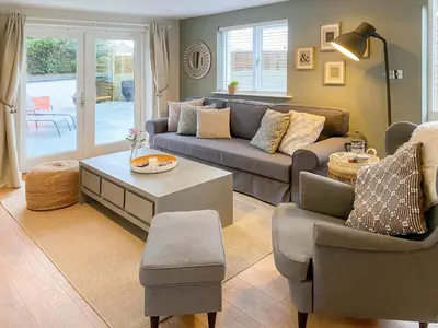 a living room with a couch and a table at High View in Truro