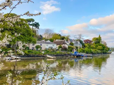 a river with houses and boats in a town at High View in Truro