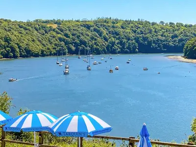 a view of a river with boats and umbrellas at High View in Truro