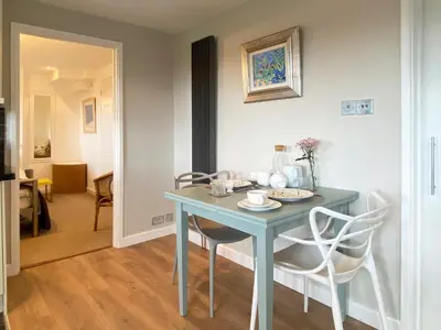 a blue table and chairs in a room at High View in Truro