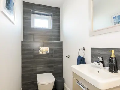 a bathroom with a toilet and a sink at Zephyr in Helston