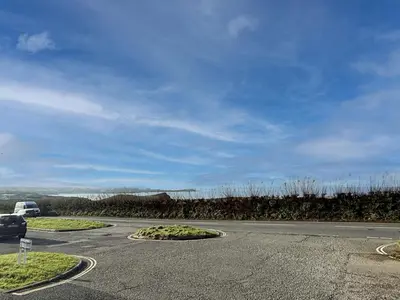 a road with a car parked on the side of it at 18 Coastline apartment in Newquay