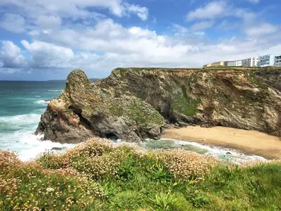 a view of a beach with a cliff and the ocean at 18 Coastline apartment in Newquay