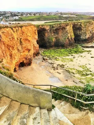 a set of stairs leading up to a cliff at 2 Watergate View in Newquay