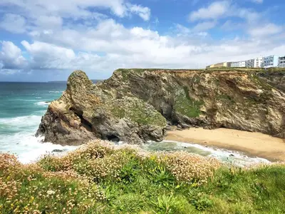 a view of a beach with a large rock at 2 Watergate View in Newquay