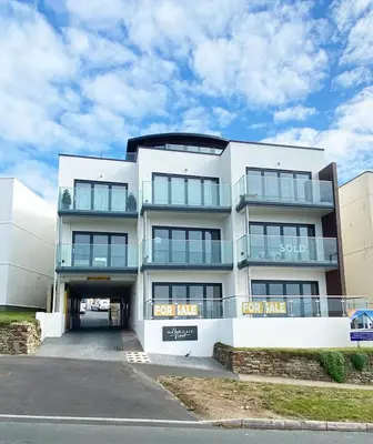 a white building with a lot of windows at 2 Watergate View in Newquay