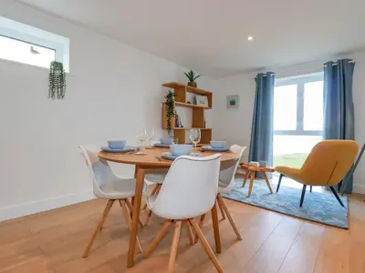 a dining room with a table and chairs at Fistral Retreat in Newquay