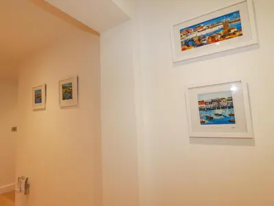 a room with three paintings on the wall at Fistral Retreat in Newquay