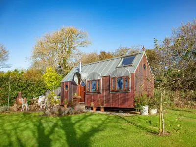 a tiny house with a metal roof in a yard at The Observatory-Uk41754 in Lanreath