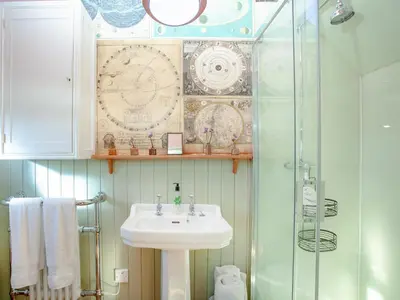a bathroom with a sink and a glass shower at The Observatory-Uk41754 in Lanreath