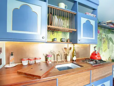 a kitchen with blue cabinets and a sink at The Tabernacle-Uk41753 in Lanreath