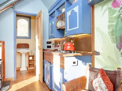 a kitchen with blue cabinets and a sink at The Tabernacle-Uk41753 in Lanreath