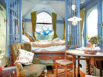a bedroom with a bed with a table and a chair at The Tabernacle-Uk41753 in Lanreath