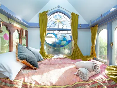 a bedroom with a large bed with a stained glass window at The Tabernacle-Uk41753 in Lanreath