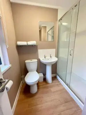 a bathroom with a toilet and a sink at Mariners Lodge in Saint Minver