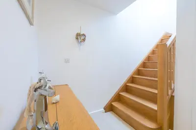 a room with a wooden table and stairs at Portside in Carbis Bay