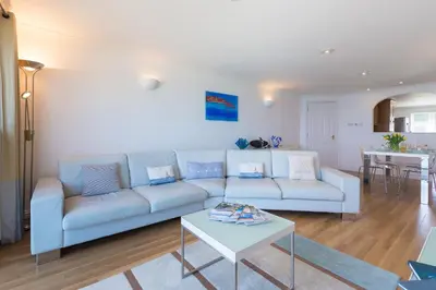 a living room with a couch and a table at Turquarze in Carbis Bay