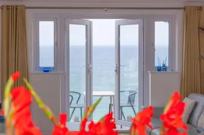 a living room with a view of the ocean at Turquarze in Carbis Bay