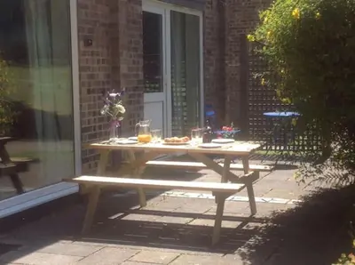 a picnic table with food on it in a patio at Cornish Point in Newquay