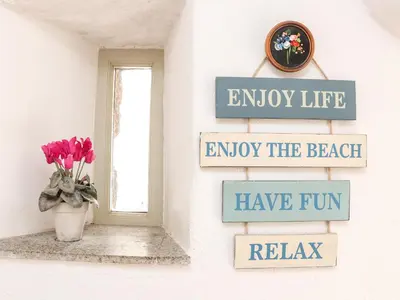 a sign that says enjoy life enjoy the beach have fun have fun relax at Larch Barn in Helston