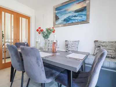 a dining room with a table and chairs at Palm View in Newquay